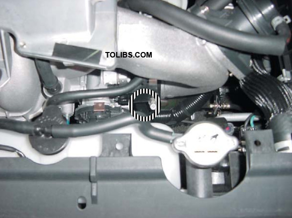 Loosen the hose clamp at the intercooler outlet where it connects to the intake manifold