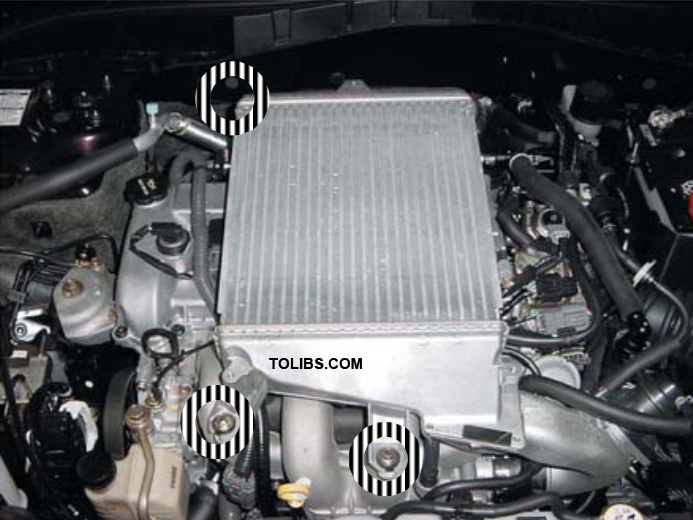Remove the three 12 mm bolts securing the intercooler to the intake