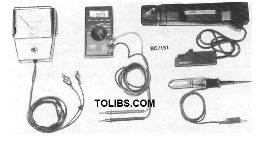 Assorted test equipment dwell tachometer, digital multimeter, timing light and test lamp.